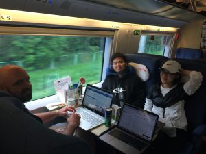 Students working on laptops on train
